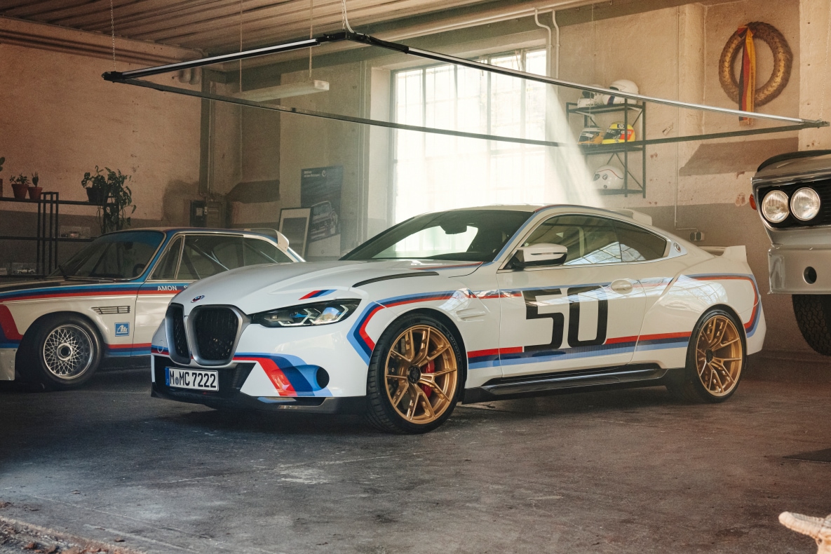 BMW 3.0 CSL in a garage, together with the original 3.0 CSL