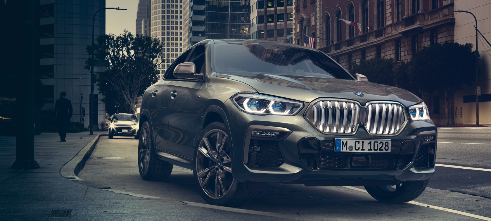 BMW X6 M50i BMW X6 M50i parking in a street of a large city