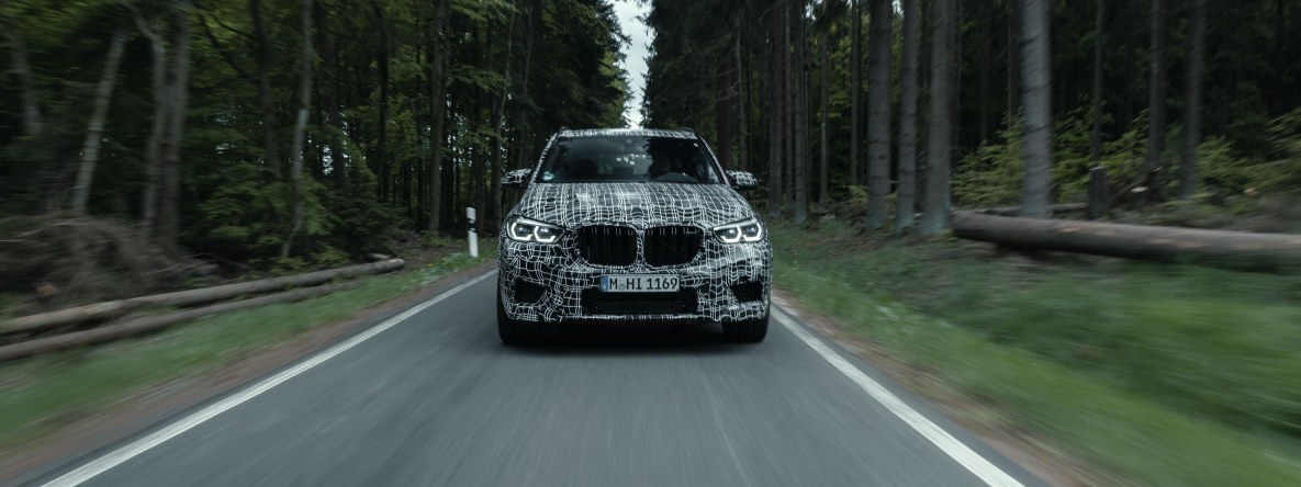 The BMW X5 M prototype on a narrow road in the Eifel mountains