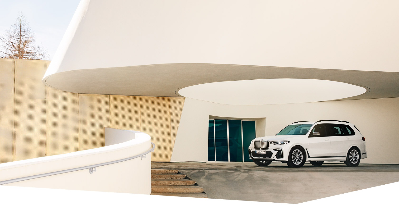 A white BMW X7 M50d in front of the 7132 in Vals, Switzerland