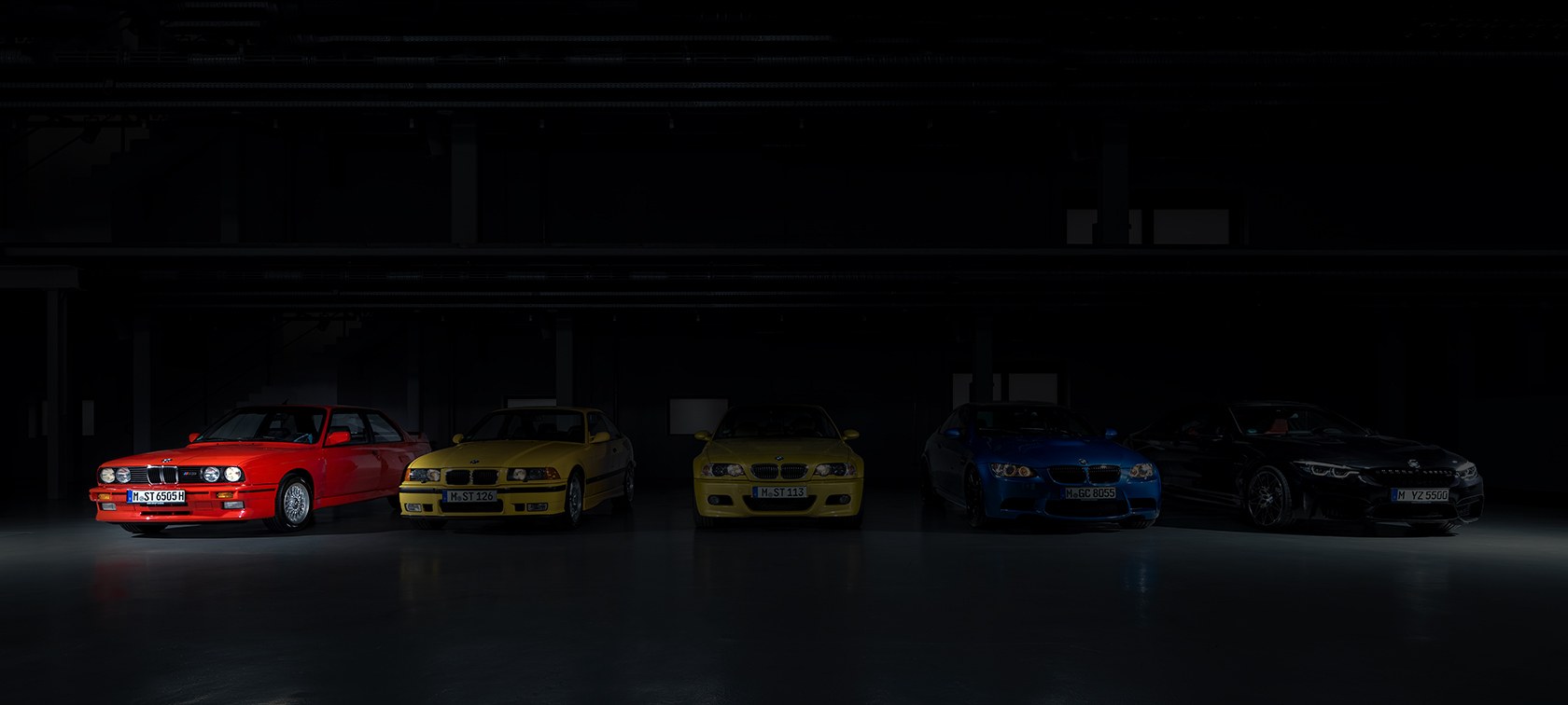 Red BMW M3 E30 in a row of M3 generations
