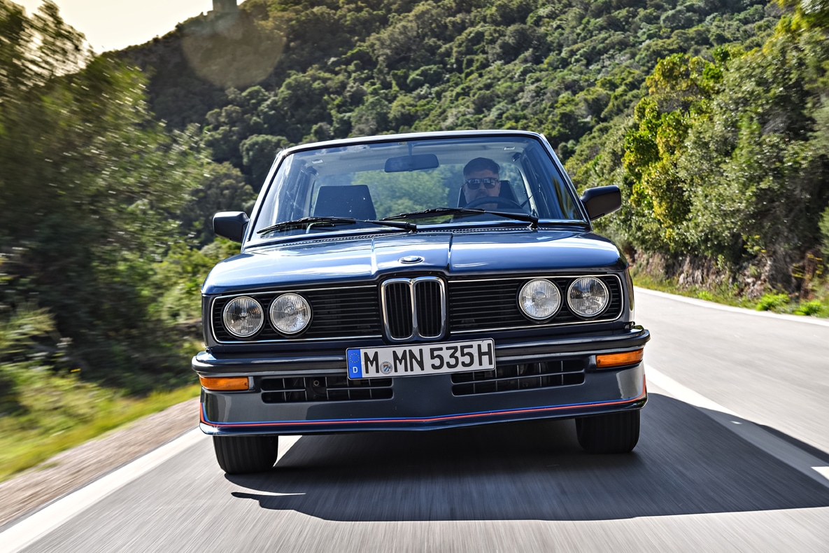 BMW E12 M535i in der Frontansicht fahrend auf der Landstraße.