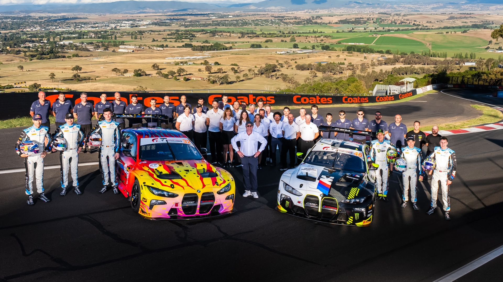 Team WRT group photo, the crew gathered around two BMW M4 GT3 EVO on the racetrack at Bathurst.
