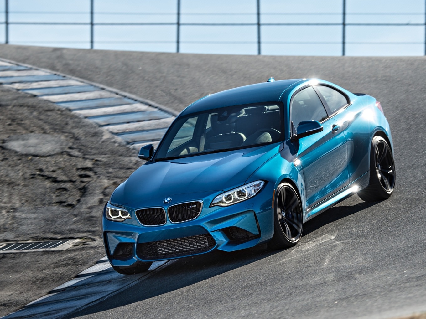 BMW M2 F87 driving on a racetrack. 
