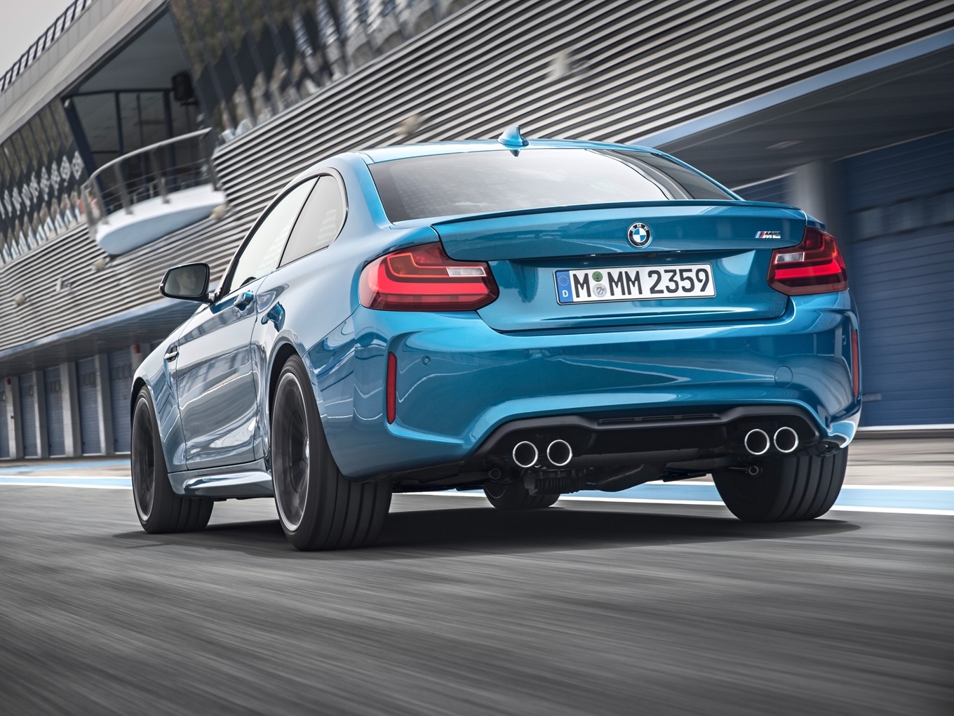 BMW M2 F87 driving on a racetrack. 