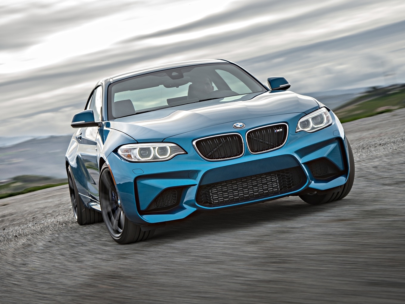 BMW M2 F87 driving on a racetrack. 