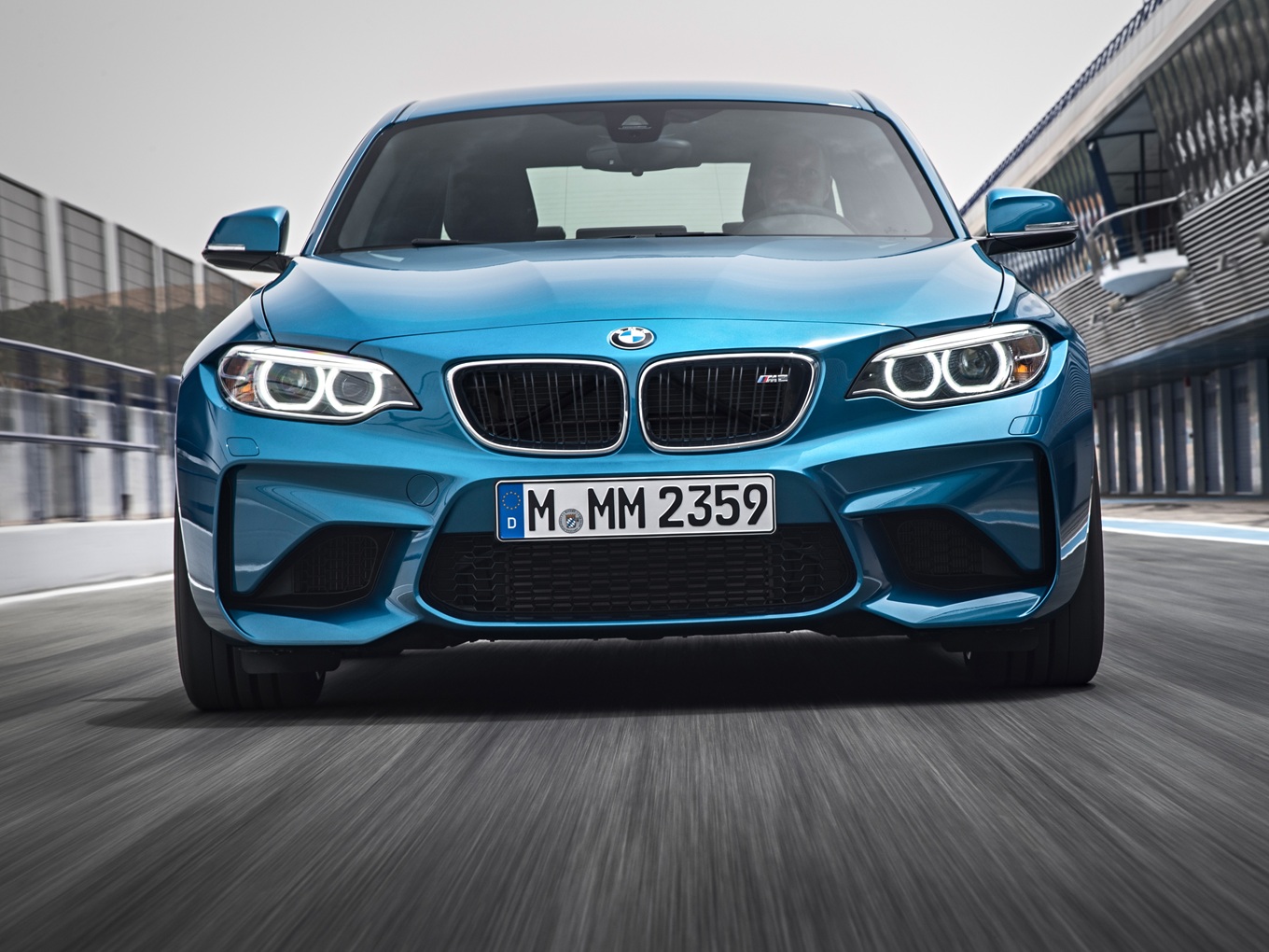 BMW M2 F87 driving on a racetrack. 