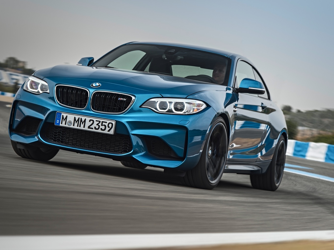 BMW M2 F87 driving on a racetrack. 