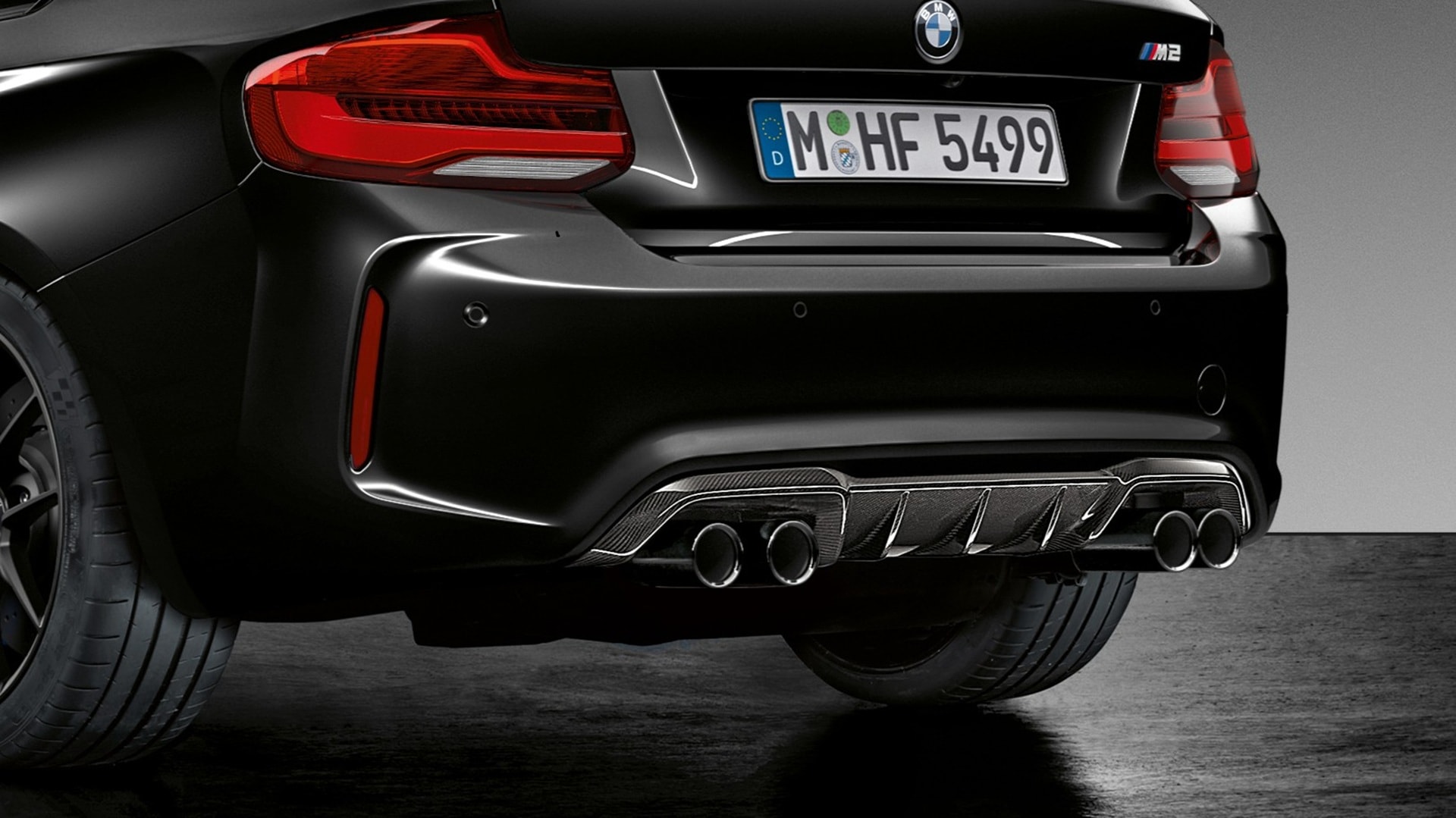 Four-pipe exhaust system with M typical twin tailpipes with black chrome trim extrending from under the rear of the BMW M2 Coupé Edition Black Shadow.