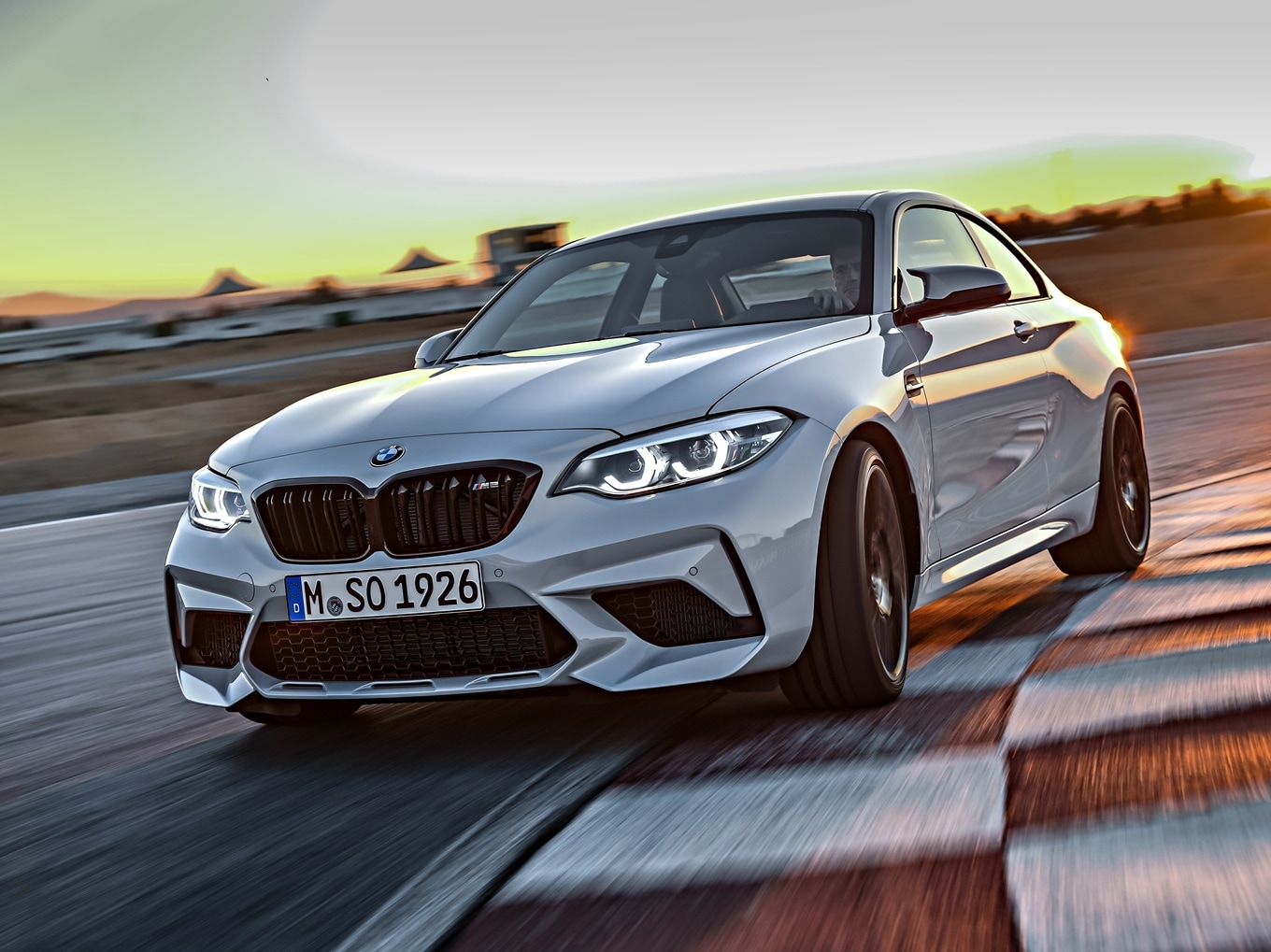  BMW M2 Competition F87 taking a curve on a racetrack.