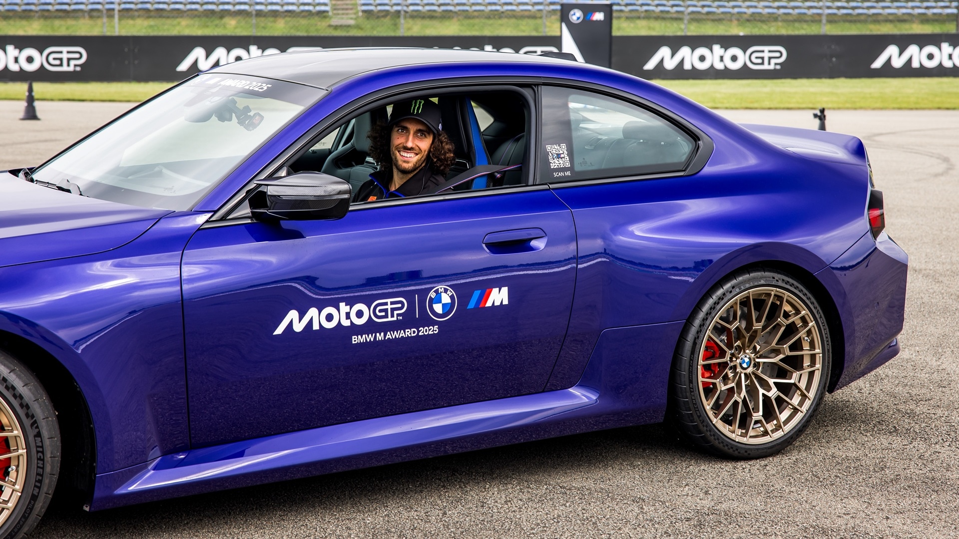 MotoGP rider Álex Rins at the wheel of a BMW M2 CS.