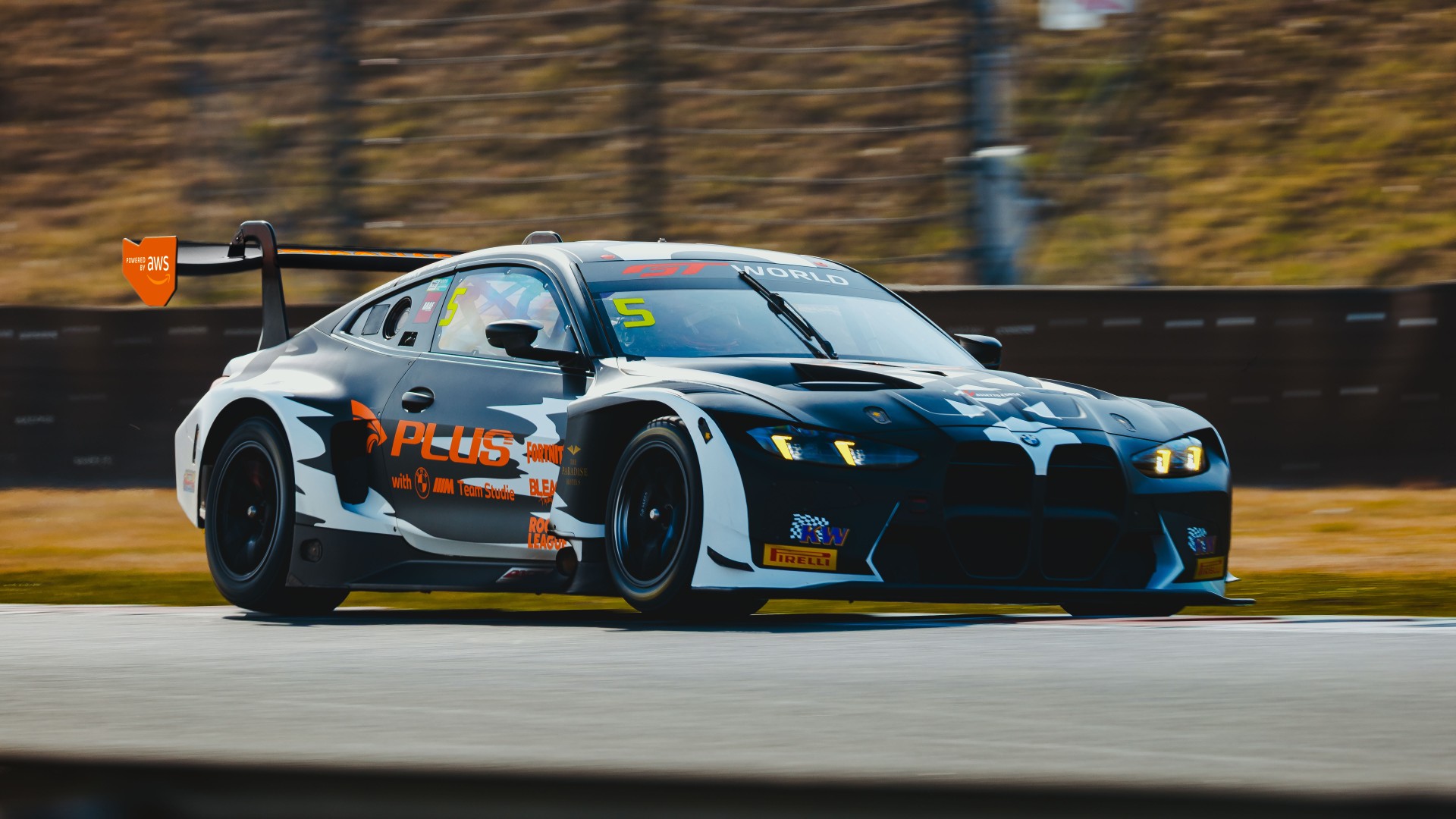 BMW M4 GT3 EVO with „BLEACH“ design driving on the racetrack