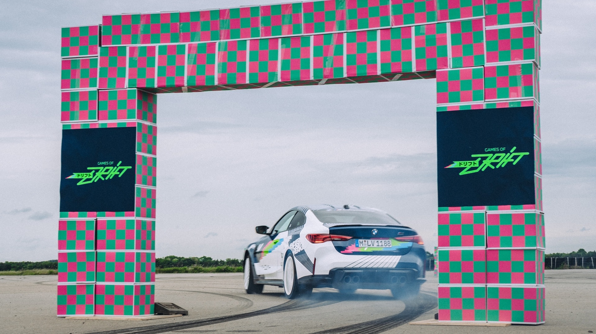 BMW M4 Competition Coupé drifts through a gate.
