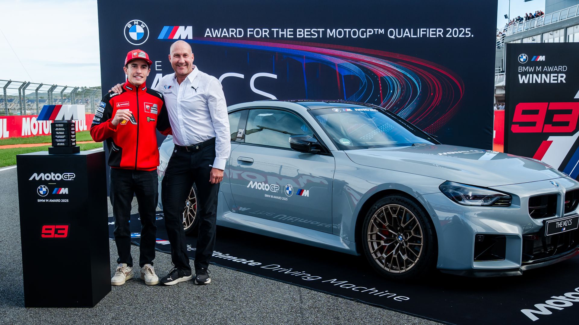 Axel Mittler of BMW M hands over the MW M Award 2025 to MotoGP rider Marc Márquez