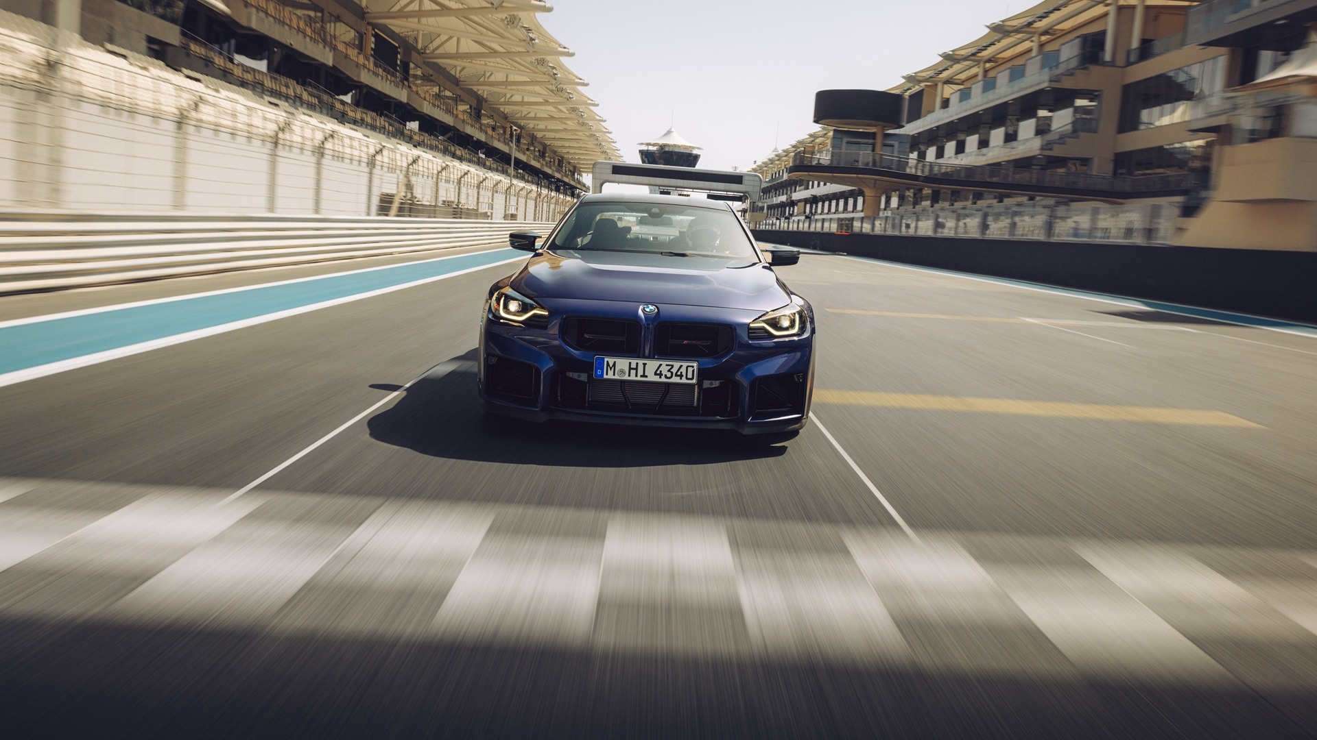 BMW M2 CS in Velvet Blue metallic on a racetrack.