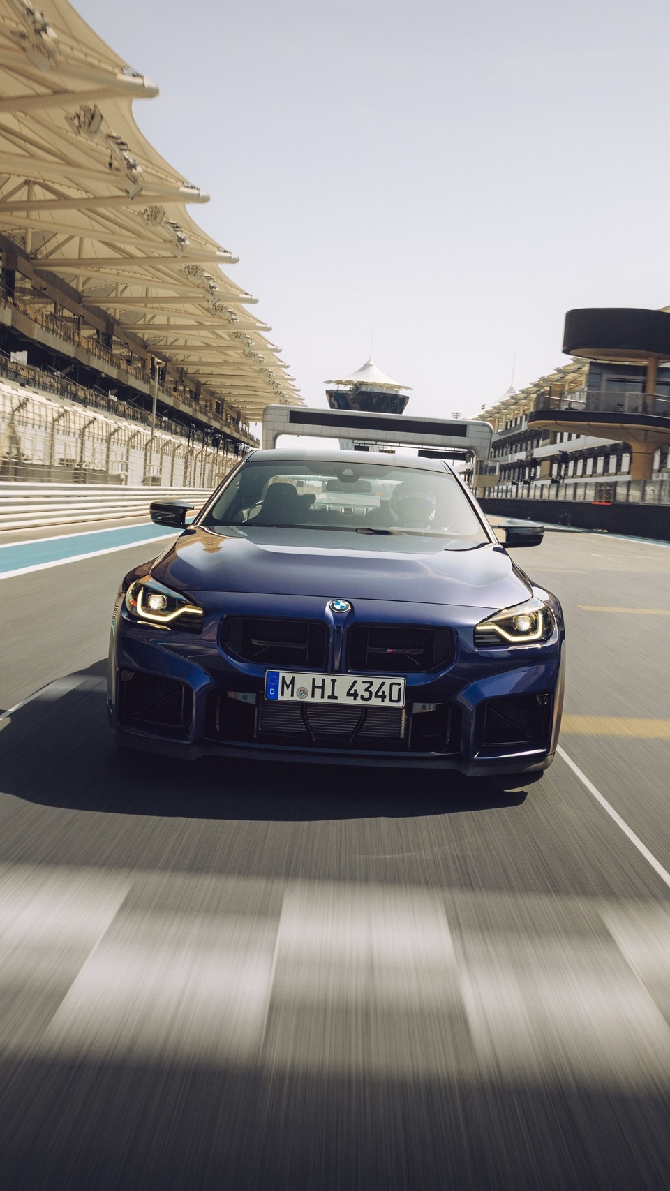 BMW M2 CS in Velvet Blue metallic on a racetrack.