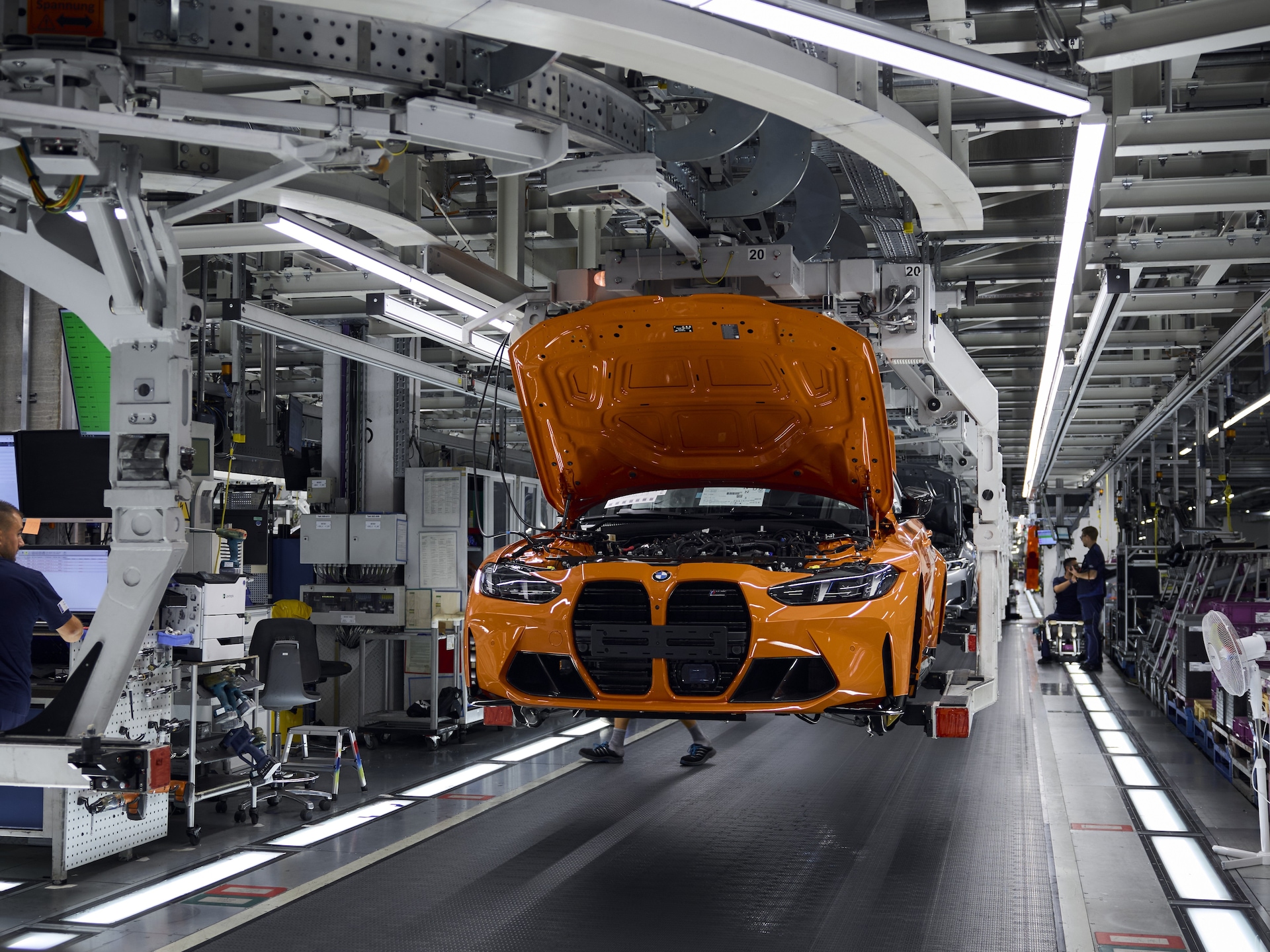 Das Jubiläumsfahrzeug BMW M3 in Feuerorange während eines Fertigungsprozesses im BMW Werk München.
