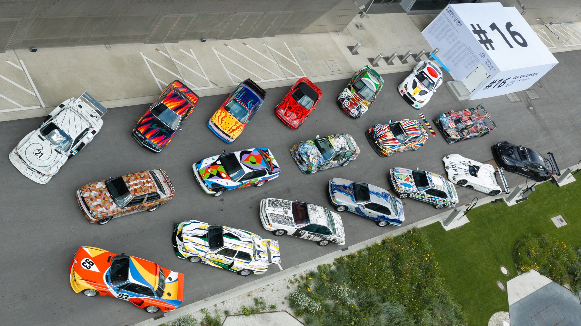 An aerial shot of all 20 BMW Art Cars, lined up outside BMW Welt, Munich.