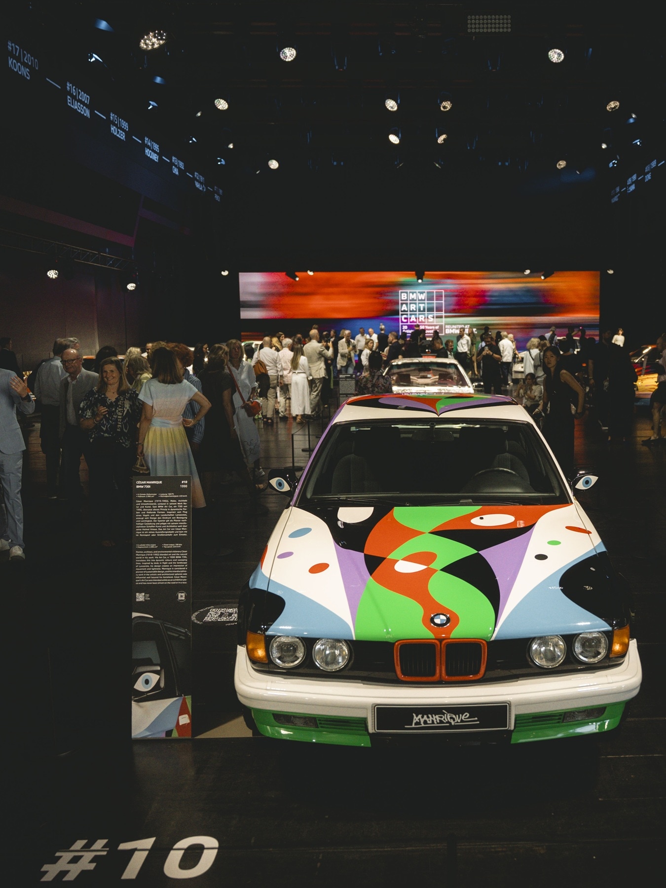 Visitors gather around the César Manrique-designed Art Car #10.
