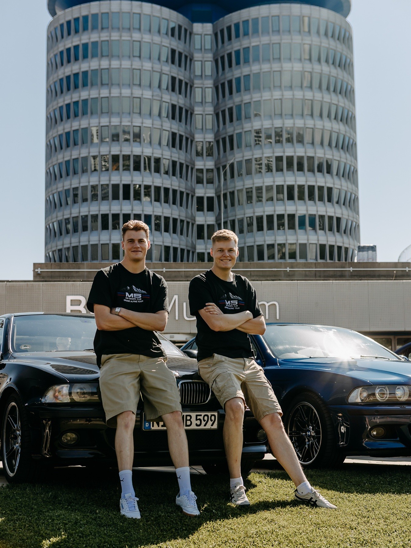 Die Brüder Malte und Julius mit ihrem BMW M5 E39 vor dem BMW Hauptgebäude in München. 