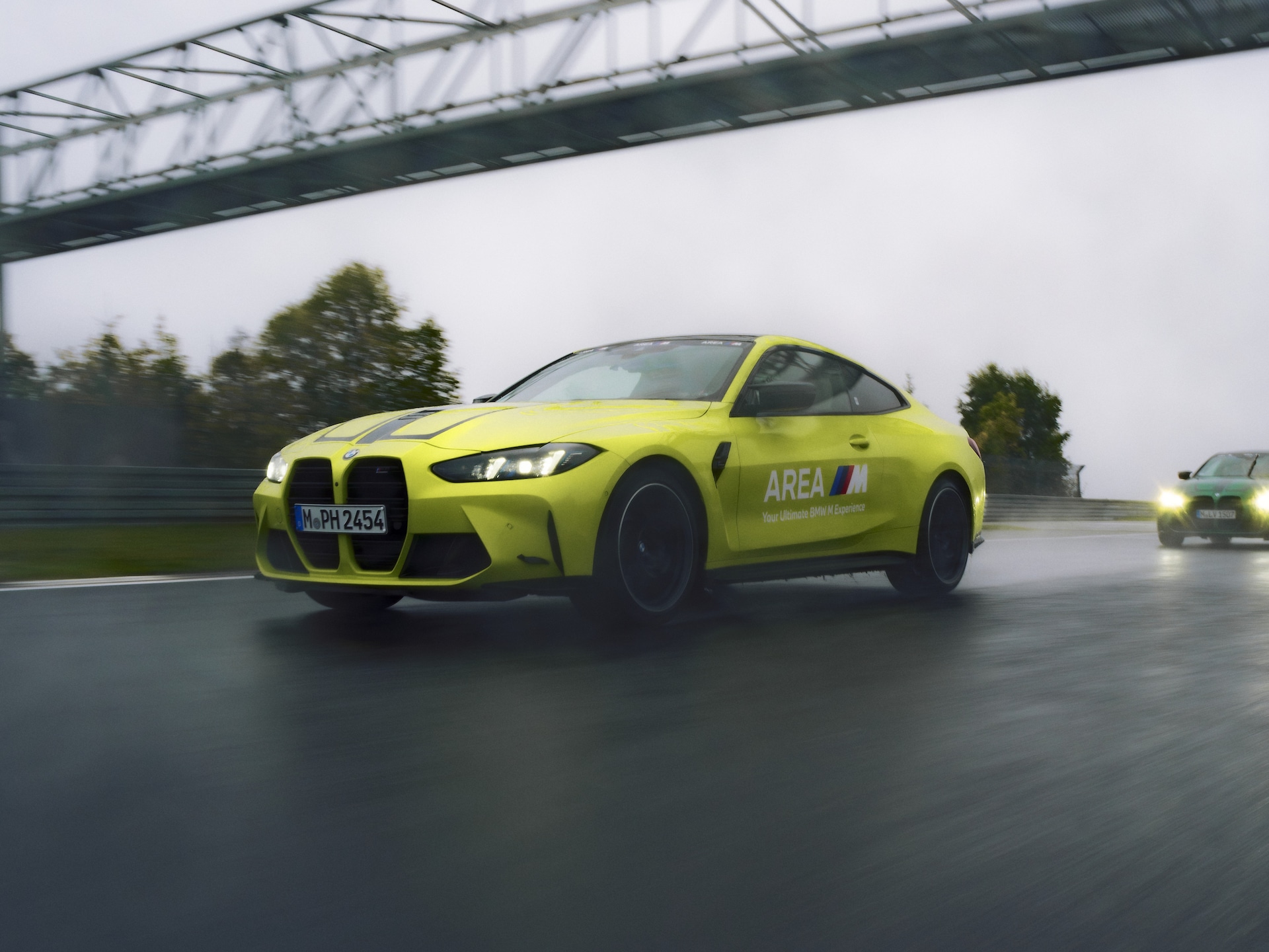 BMW M4 Competition Coupé driving on a racetrack.