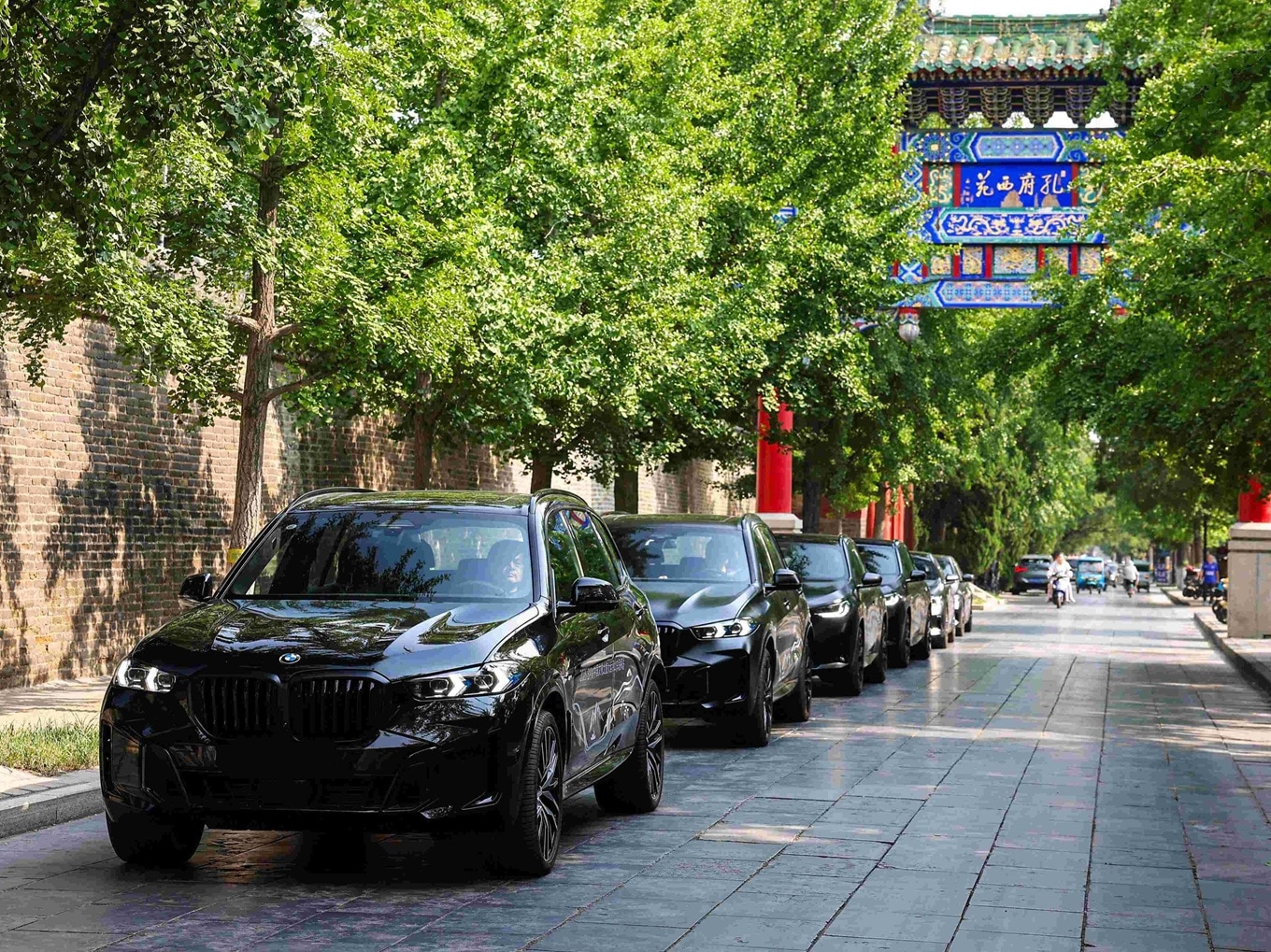 A row of BMW X5 models, parking in an urban street in China