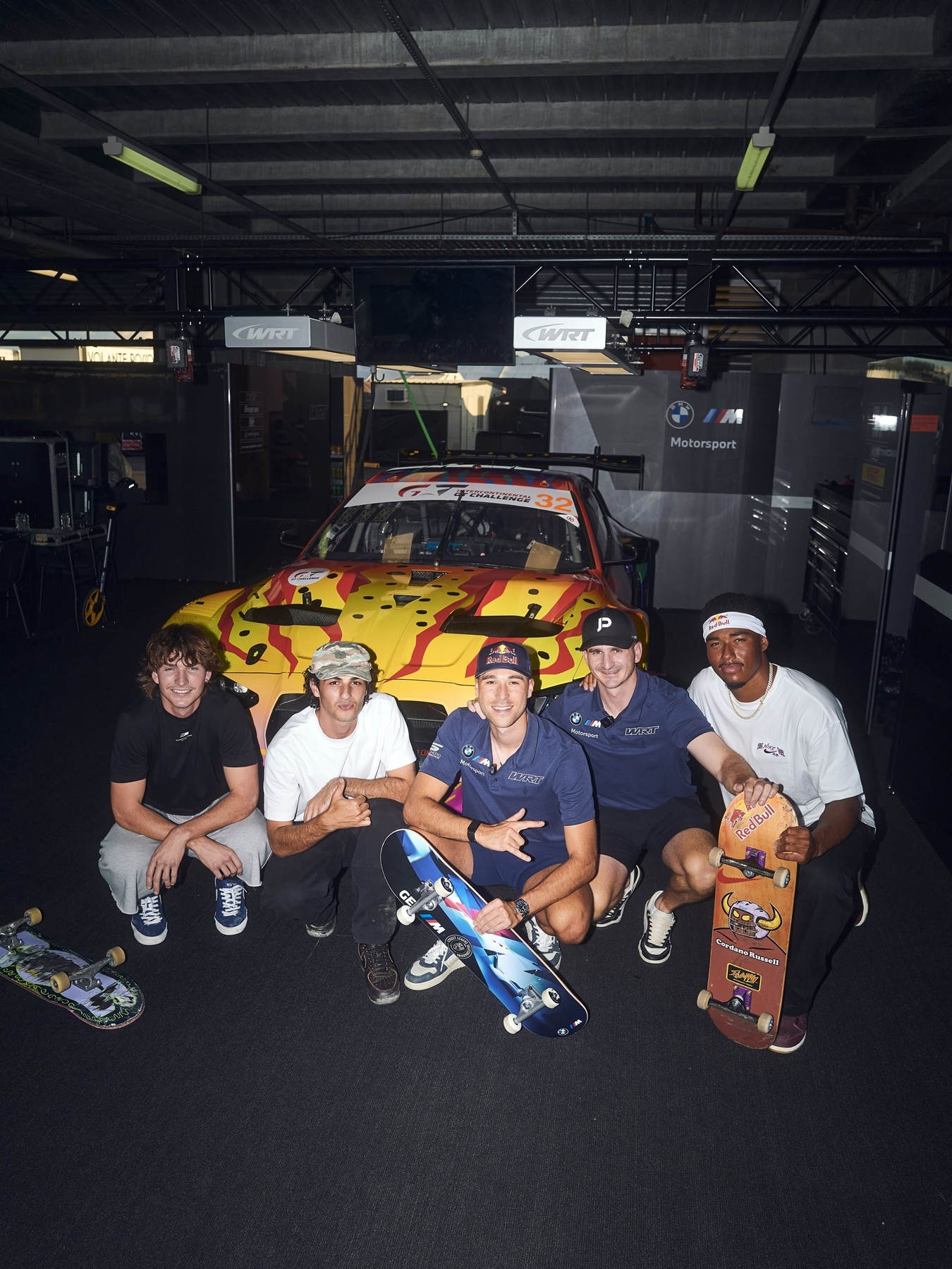 Riley Pavey, Noah Nayef and Cordano Russel (r) posing with works drivers Sheldon van der Linde and Jordan Pepper before a race-ready BMW M4 GT3 EVO. 