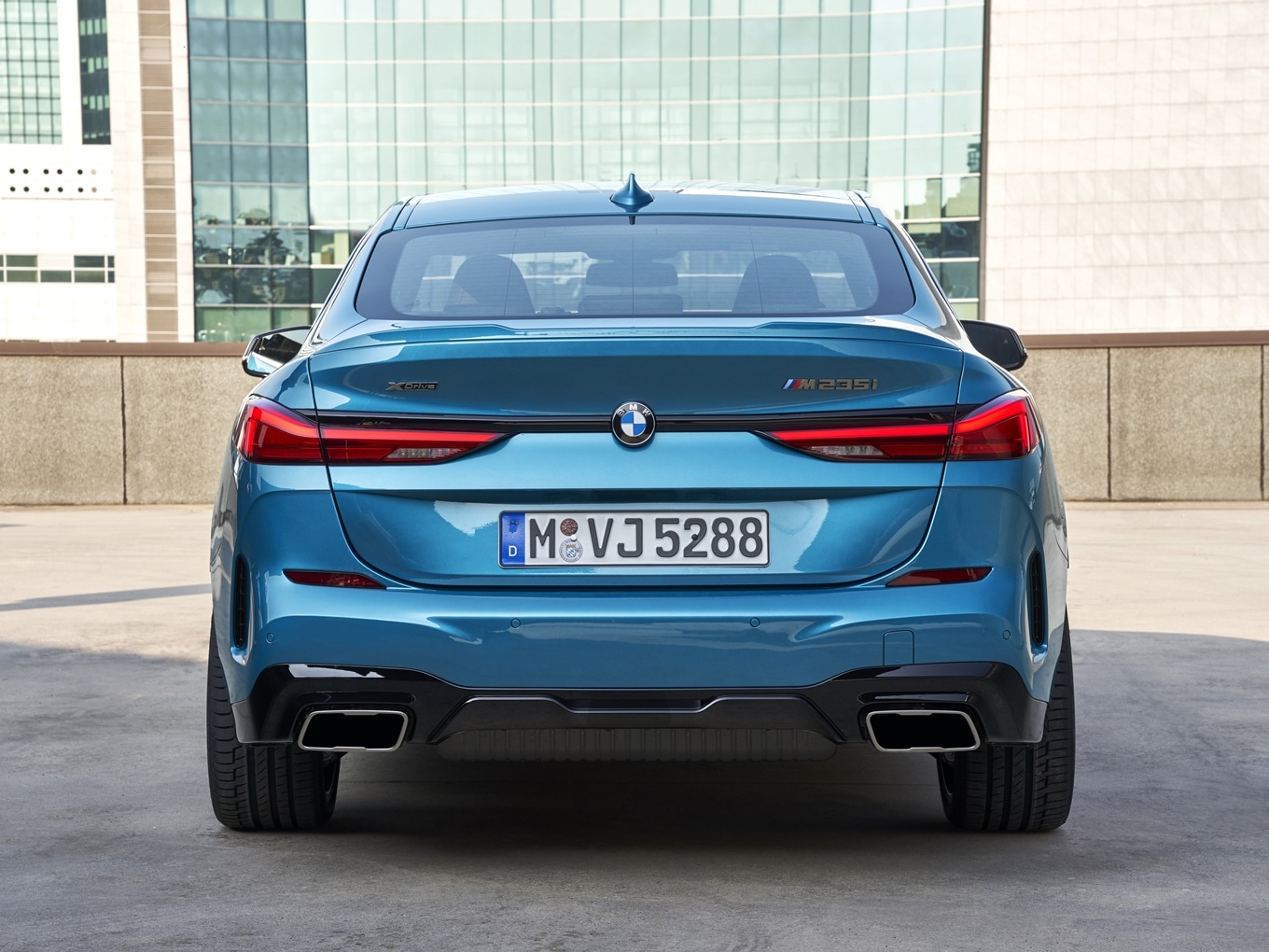Rear view of a BMW M235i xDrive Gran Coupé F44 on a rooftop car park. 