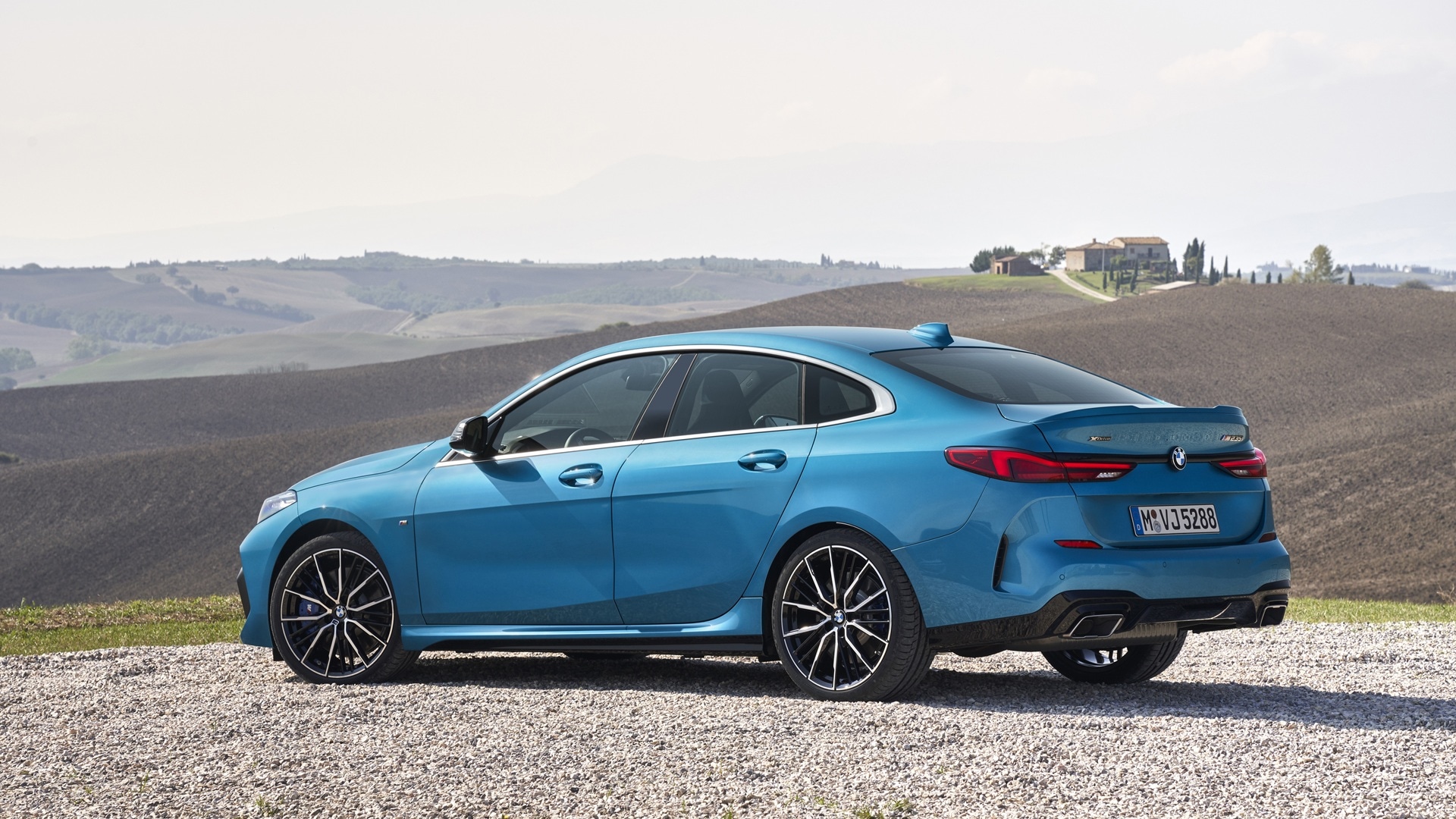 BMW M235i xDrive Gran Coupé F44 before the backdrop of a Tuscan landscape. 
