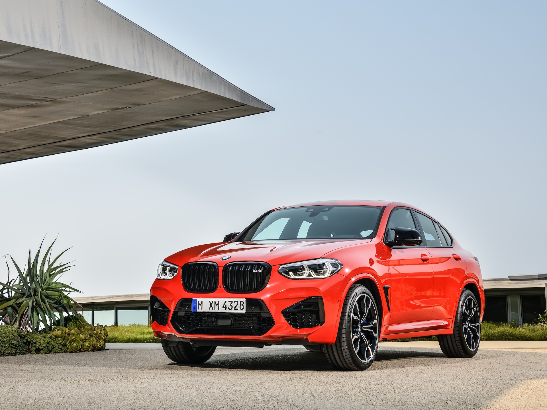 Front view of the BMW X4 M Competition F98 with large air intakes.