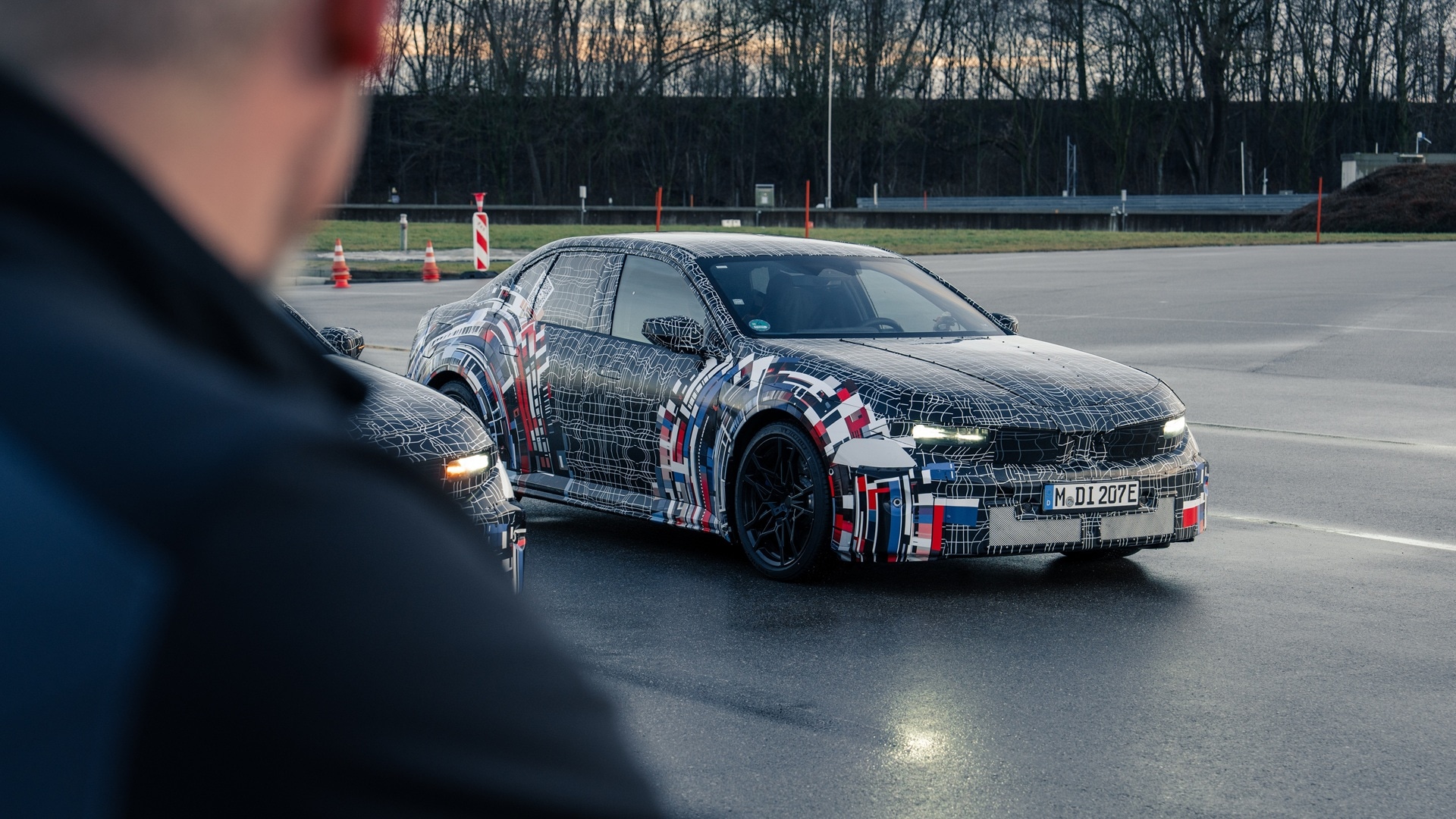 Two BMW M fully electric drivetrain test vehicles on a test track.