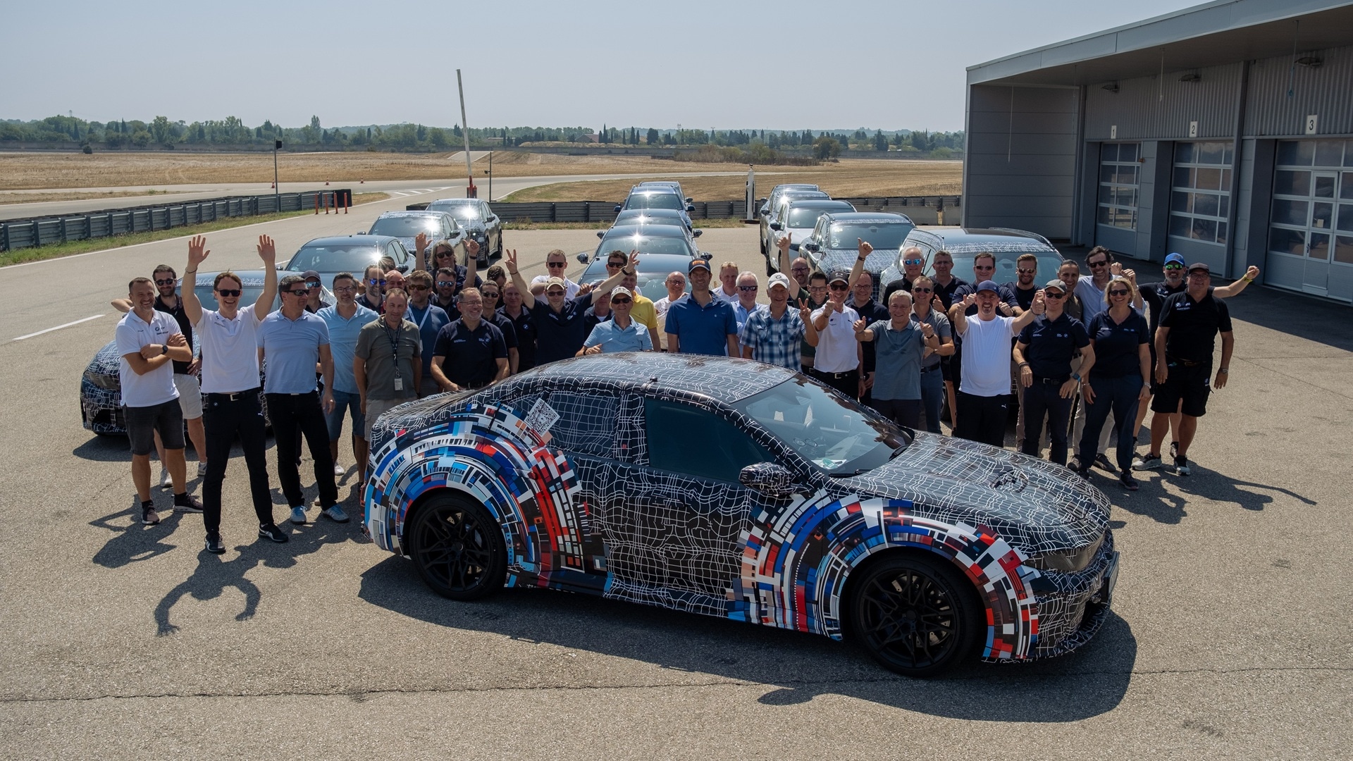 The engineering developers with the pre-production BMW M3 at the test track in Miramas.