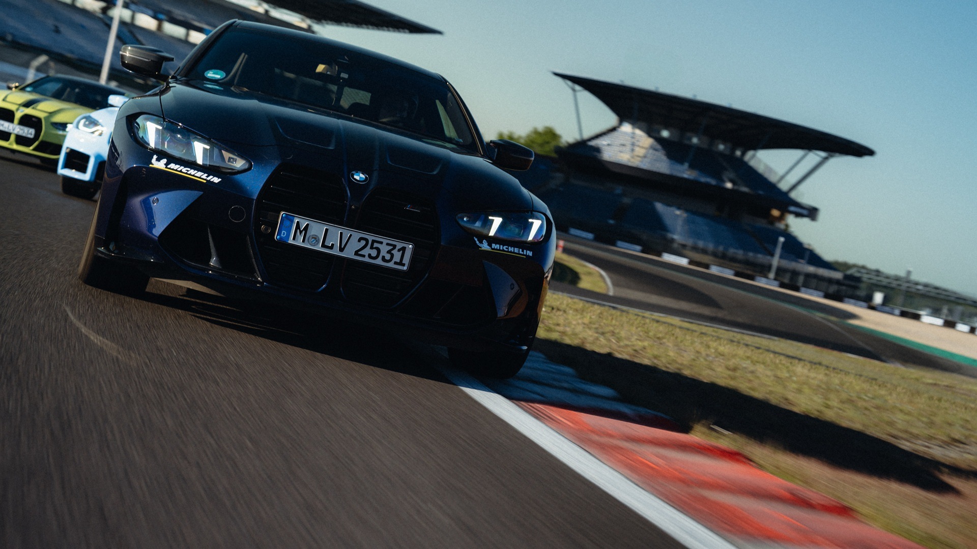 Three BMW M4 during a driver's training on a racetrack. 