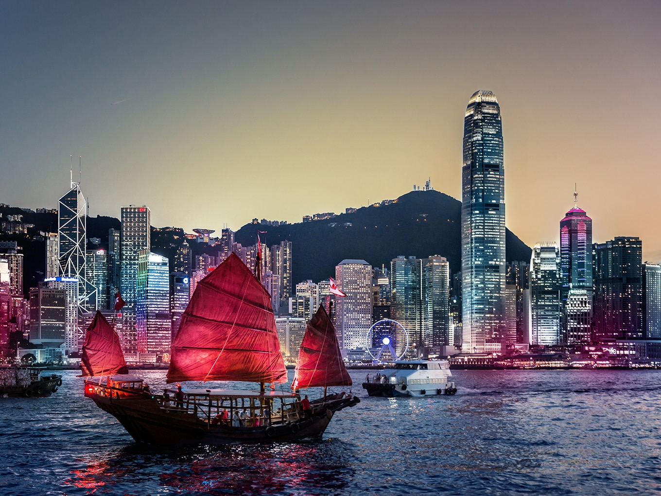 Blick mit vorbeigleitender Dschunke auf Victoria Harbour und Hongkong Central.
