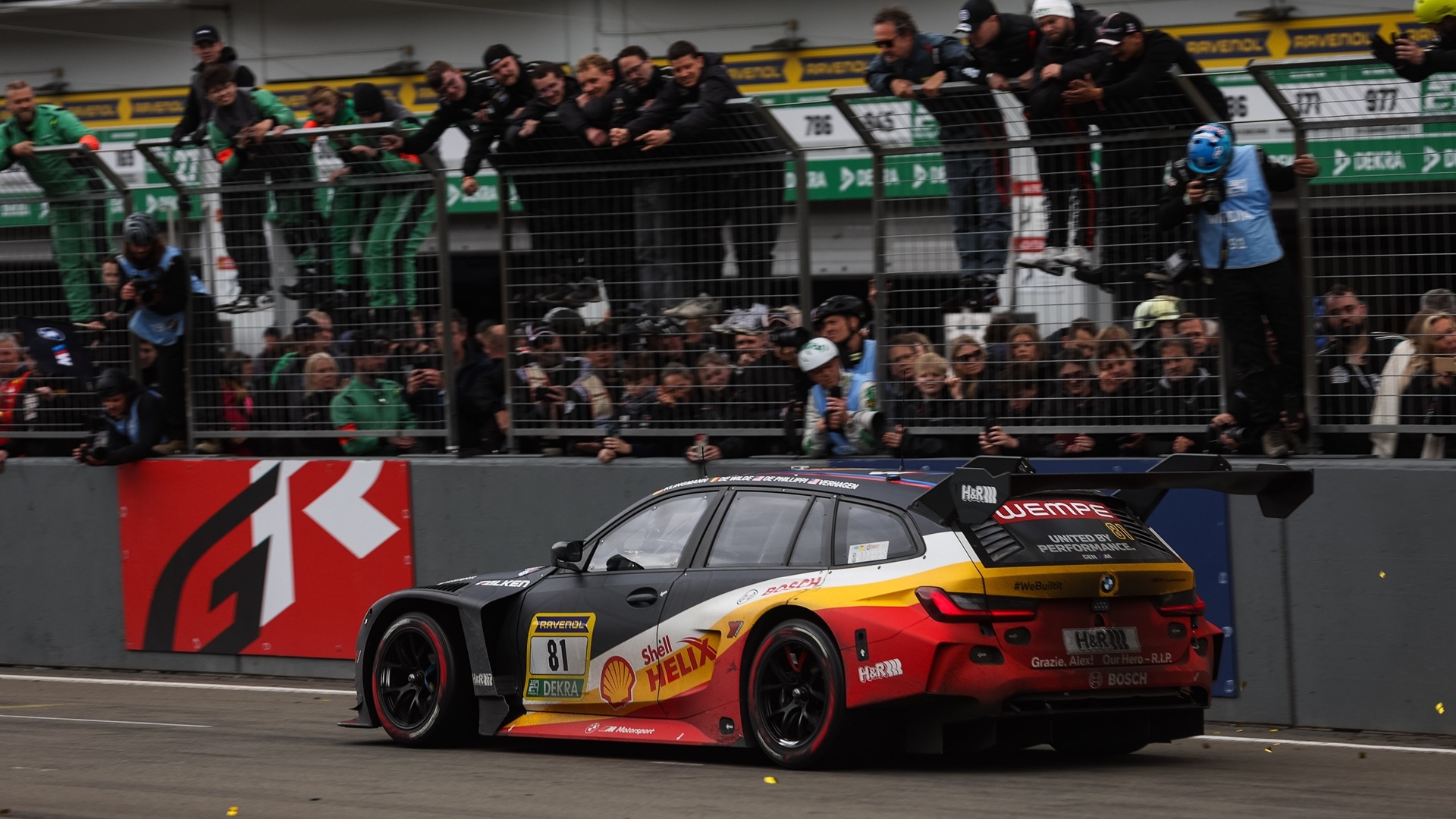The BMW M3 Touring 24H getting cheers from fans at the Nürburgring grandstand.