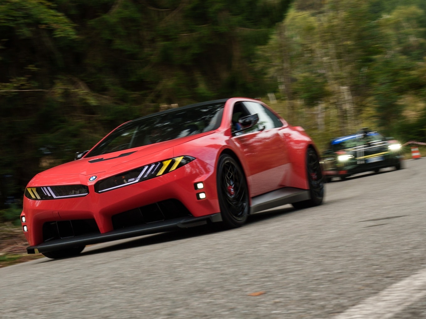 BMW M Concept Neue Klasse driving on a mountain road.
